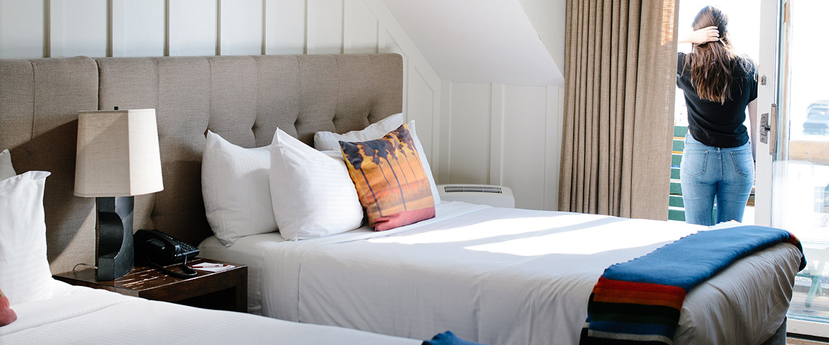 Double bedroom with a woman enjoying her view